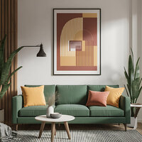 Modern living room with a green sofa, colorful pillows, abstract wall art, and plants, styled in warm earthy tones.