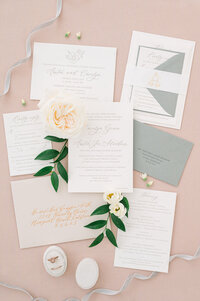 Letterpress wedding invitation with neutral colors, gold calligraphy, gold foil belly band