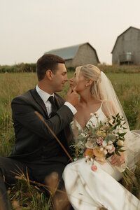 bride and groom embrace on wedding day in pei