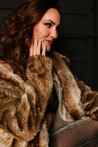 Side profile photo of Juliet Trnka in a fur coat