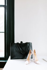 heels and a black purse sitting on the counter