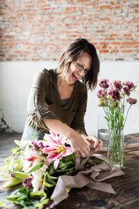 Nashville florist joyfully designing a floral bouquet in Columbia, TN