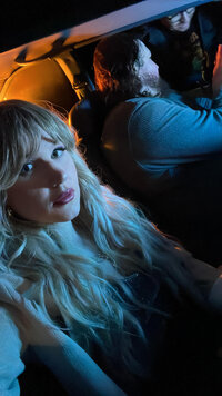 Indie film producer and Cassi Angier in a photo taken on set in a vehicle. 