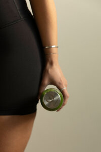 Client holding a smartphone, representing convenience and personalized fitness tracking with Synergy EMS.