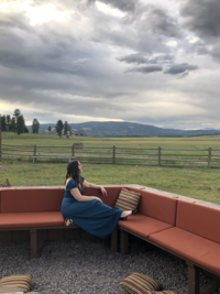 Mikaela Kahn live wedding vocalist sitting on an outdoor couch