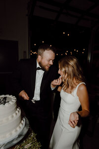 bride and groom share cake on wedding day