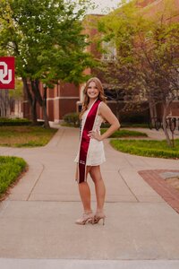 girl posing on campus for senior photos in dallas