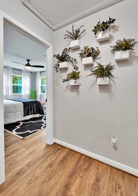 Bedroom and greenery wall of this 2-bedroom, 2-bathroom bungalow on the Brazos River outside of Waco, TX