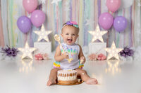 baby girl celebrates her first birthday with a pastel star themed set