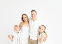 Family posing for a studio Portrait at Christmas time by Lauren Vanier Photography