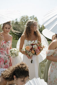bride with her bridesmaids and pink color bouquets