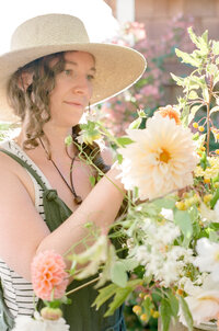 seattle florist holding a bucket of flowers