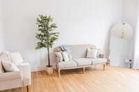 a photography studio staged with a comfy couch