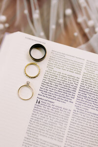 Bible verse about love and the couples wedding rings on top of the bible. 
