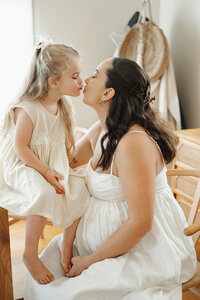 toddler kisses mum at in home maternity photography session in Melbourne