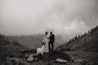 black and white image bride and groom embracing on mountain