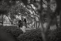 Bride and groom in garden embrace