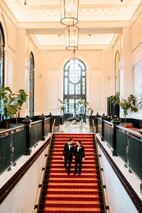 Couple walking down church aisle