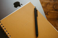 Set of notebook and Macbook for researching and pitching guest posting opportunities | The Comma Mama Co.