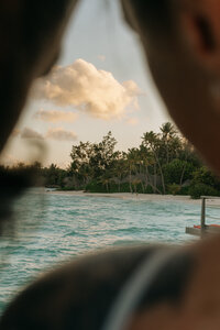 A breathtaking Bora Bora wedding scene where the newlyweds admire the endless turquoise waters, capturing the essence of romance, travel, and timeless elegance.