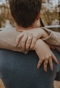 Newly Engaged couple wearing casual clothes on the austin boardwalk in Austin. Engagement photo by photographer in Austin | Photos by Meggie
