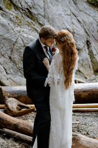 Bride holding her husband close to her at their wedding in Whytecliff Park