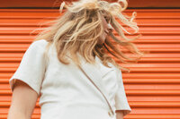 Photographer Marcie Jean shakes her hair.