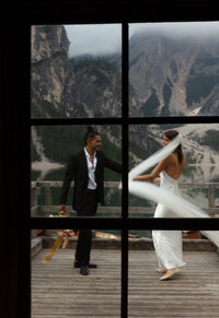 Bride and groom framed in a window with mountain views, photographed by a Utah destination wedding photographer.