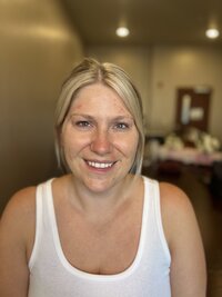 Blonde woman before makeup in white tank top