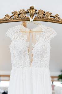 Close up of bridal dress hanging on a mirror