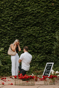 A person kneeling down and proposing to their partner