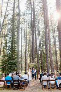 woodland wedding ceremony with arch