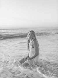 High School Senior Sitting In The Water At The Beach