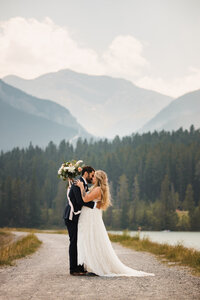 summer calgary wedding during BC wild fires. Bride and groom share a candid moment, documented by professional photographer Carly Hill.