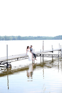 Bride and groom  on the dock at the lake