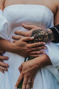 Man and woman embrace from behind