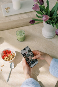 Healthy morning routine scene with matcha latte, granola, and fresh tulips