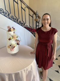 Brooke smiling in a red dress