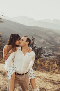 Couple kissing in a forest in the French Alps