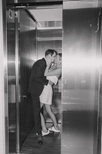 Bride and groom share a private passionate kiss in the elevator heading up to their wedding reception at the Blue Ocean Event Center in Salisbury, MA