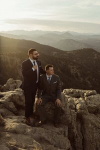 Two Grooms watching the sunset after their elopement at Lost Gulch 