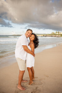 Maui Wedding Photographer captures couple hugging on beach after sunset beach wedding
