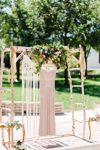 wedding dress hanging  on ceremony arch with flowers ceremony arch inspiration, chicago weddings
