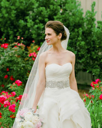 Portrait of Bride looking to her right and holding her boquuet
