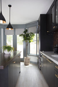 A new kitchen layout in a Westwood home featuring dark grey kitchen cabinets, designed by a top kitchen designer in Boston for a sleek, modern look.