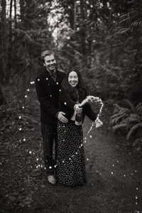 black and white engagement image popping champagne