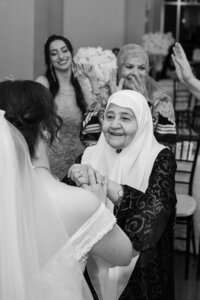 candid moment of bride greeting her grandmother
