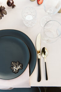 Black and gold place setting with La Tavola linens and custom acrylic place card at the War Memorial in Grosse Pointe Michigan
