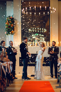 Bride and groom dancing and smiling while staring into each other’s eyes.