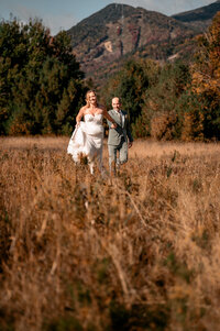 A couple dancing in a field in front of whiteface mountain in upstate NY